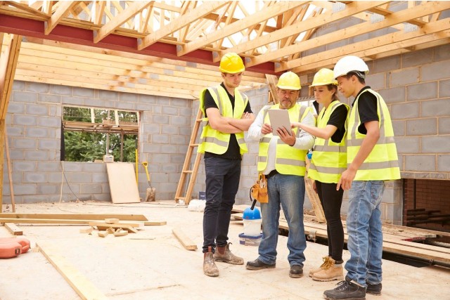 team-of-worker-looking-into-the-plans